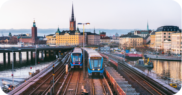 Two trains pull out of a European train station